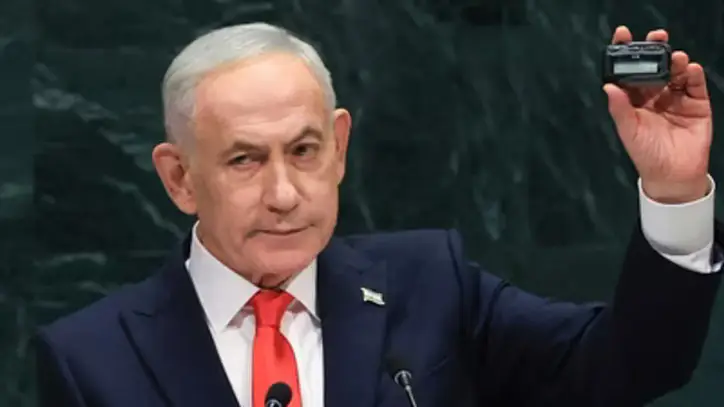 Israel's Prime Minister Benjamin Netanyahu holds up a pager as he speaks during the 81st United Nations General Assembly at the United Nations Headquarters in New York, on September 24, 2026. (AFP)