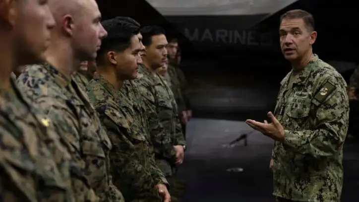 US Navy Admiral Brad Cooper, commander of US CENTCOM, speaks with crew members of the America-class amphibious assault ship USS Tripoli, deployed to the US 5th Fleet area of operations to support maritime security in the Middle East, in this handout photo released May 3, 2026.