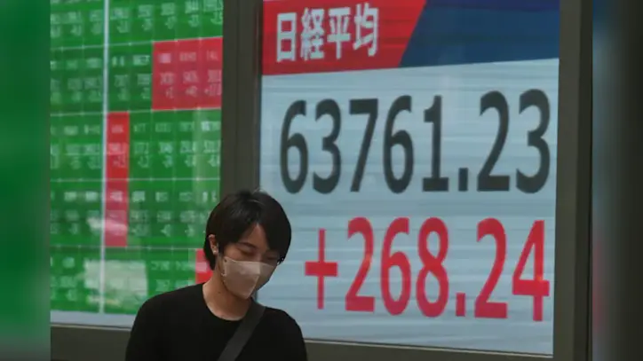 Global shares trade mostly lower after AI stocks sink on Wall Street