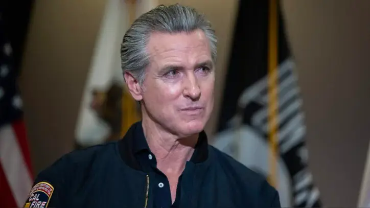 Gov. Gavin Newsom listens to speakers before signing legislation targeting "claim sharks," private companies that charge veterans fees for help with disability claims, during a news conference Tuesday, Feb. 10, 2026. On Wednesday, Sept. 23, 2026, he named four people to advise Californians about artificial intelligence.