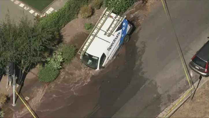 Photos: Spectrum van caught in sinkhole in Los Angeles neighborhood