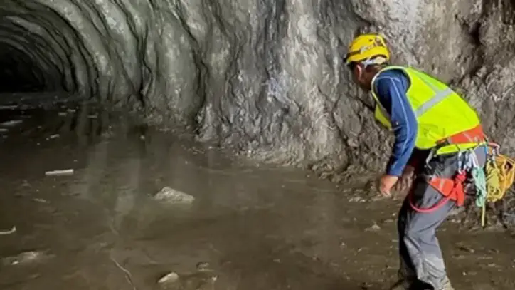 A rescuer works at the entrance of a tunnel at Chilime Hydropower Plant as rescue operations continue for people trapped inside following deadly flash floods and a mudslide, in Rasuwa, Nepal. (REUTERS)