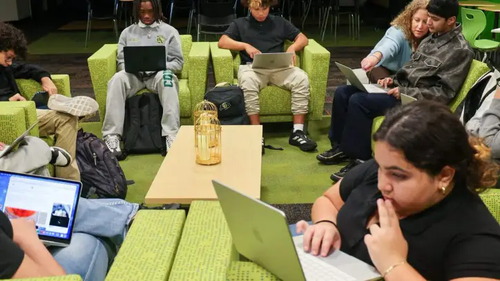 Miami Killian Senior High School freshman and sophomore students work on the their design assignment as teacher Oberlander, upper right, gives personal instructions during the Digital Design art class on Monday, Aug. 24, 2026, in Miami. Killian has experienced the fastest-declining enrollment of any public school in Miami-Dade County, losing more than 80% of its students over the past 20 years.