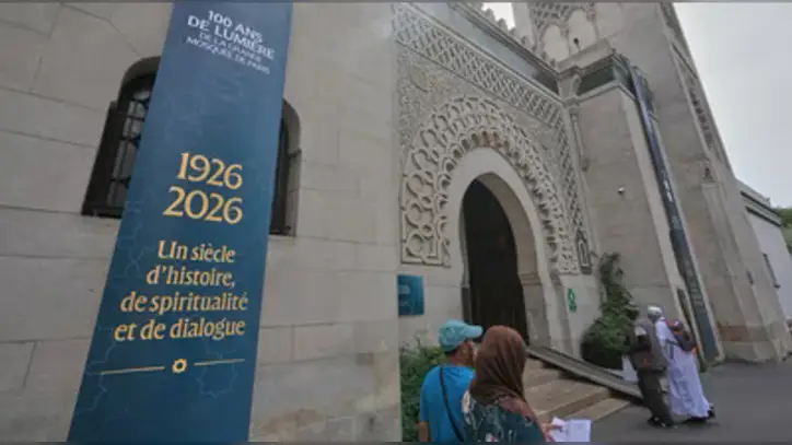 People walk past the Grand Mosque of Paris, where a banner reads, "100 years of light, a century of history, spirituality and dialogue" marking its 100th anniversary, Friday, July 17, 2026 (AP)