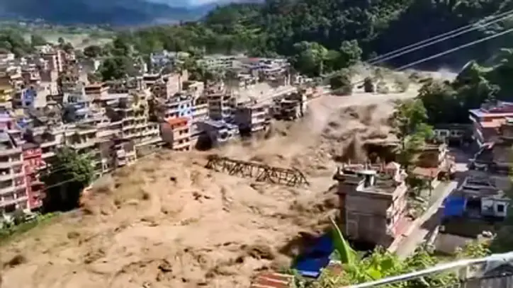 Nepal floods: In this screengrab from a video posted on Aug. 26, 2026, Floodwater flows across a residential area, in Nepal. (PTI)