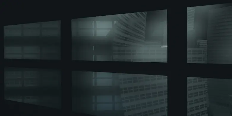 A dark room with multiple windows and a clock on the wall